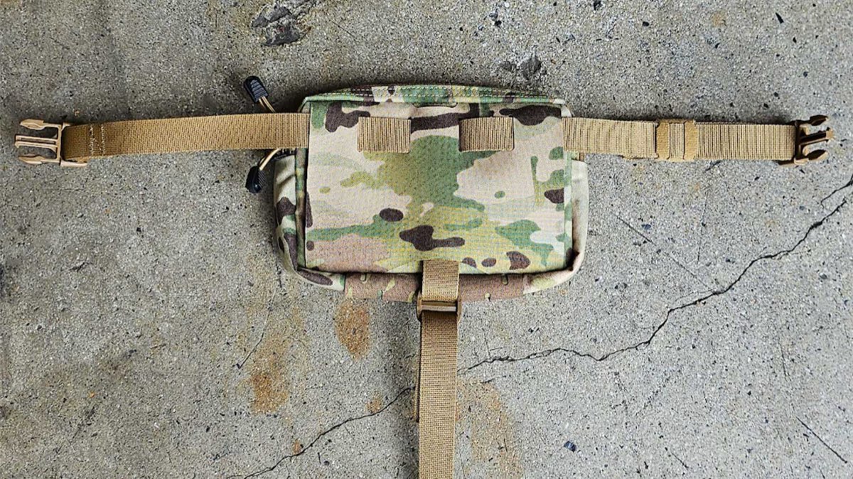 INVRT Revolver Pack with the main strap woven through its slots